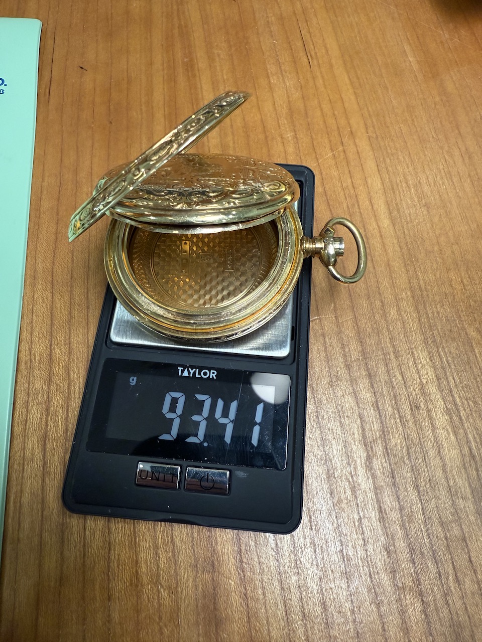 Hampden Watch Co 18s pocket watch on scale showing case weight